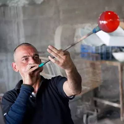 A glass blower demonstrates his skill.