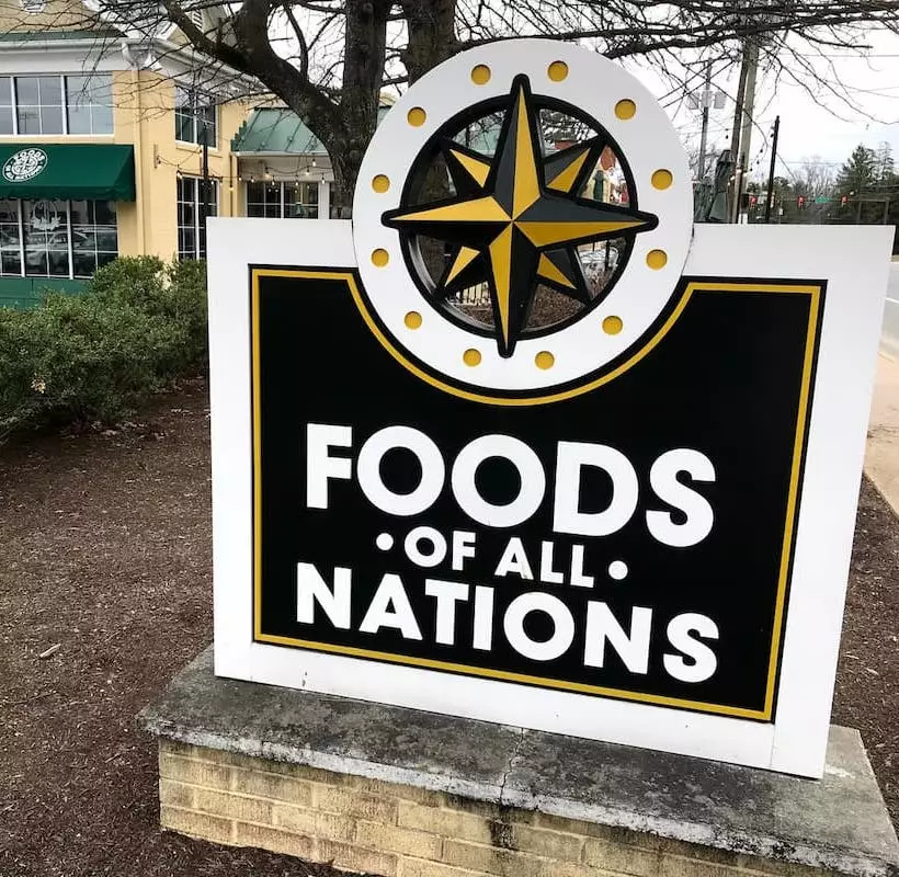 Outside view of Foods of All Nations and their sign.