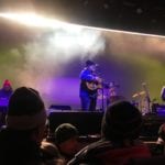Jeff Tweedy plays guitar on stage.