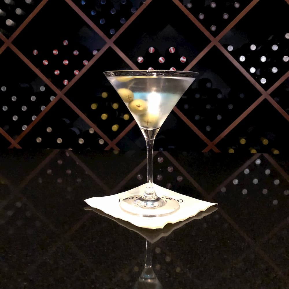 a crisp martini in a glass with olives