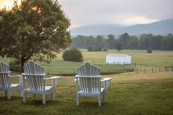 Adirondack chairs facing mountains
