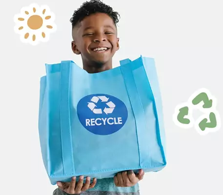 Happy child with a recycling bag.